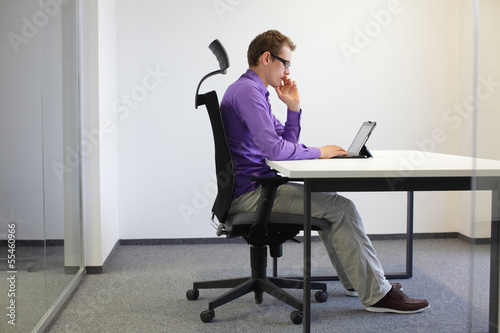 correct sitting position at desk with tablet photo