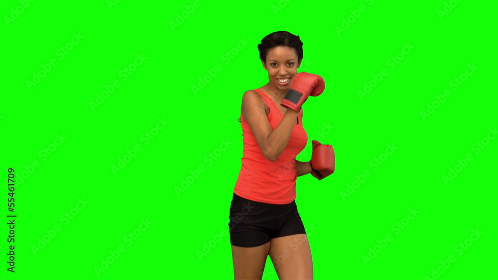Woman performing air kick on green screen Woman performing air kick on green screen