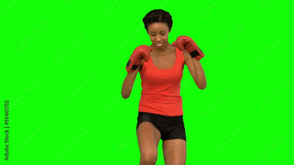 Woman performing high kick on green screen Woman performing high kick on green screen