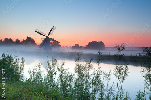 Dutch white windmill at sunrise