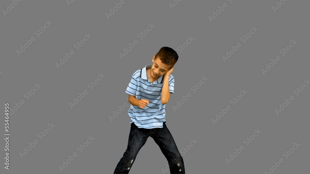 Little boy dancing on grey screen Little boy dancing on grey screen