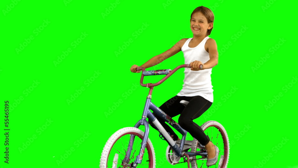 Little girl riding bike on green screen Little girl riding bike on green screen