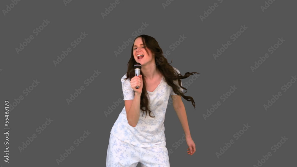 Happy young model in pyjamas singing Happy young model in pyjamas singing