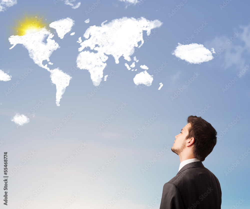 Businessman looking at world clouds and sun on blue sky Businessman looking at world clouds and sun on blue sky