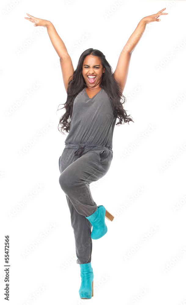 Woman standing with arms raised and happy expression Woman standing with arms raised and happy expression