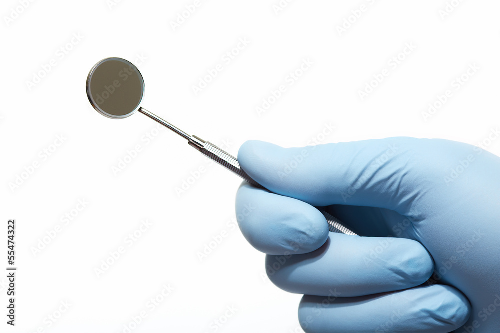 Hand with professional dental tools. Hand with professional dental tools.