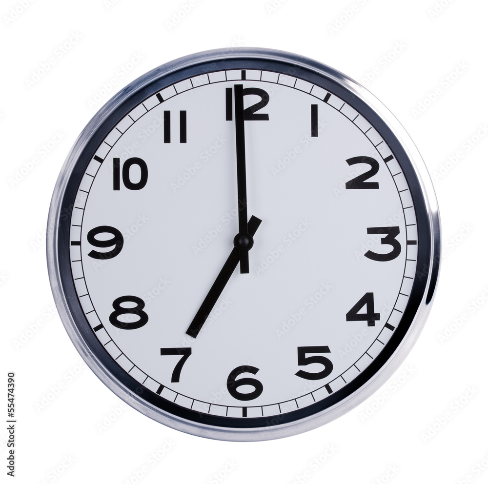 Round office clock shows seven o'clock Round office clock shows seven o'clock