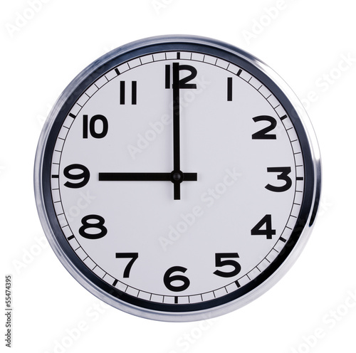 Round office clock shows nine o'clock