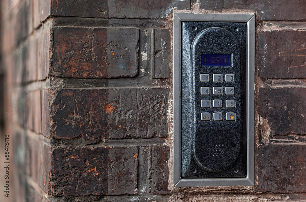 Old intercom on a red brick wall Old intercom on a red brick wall