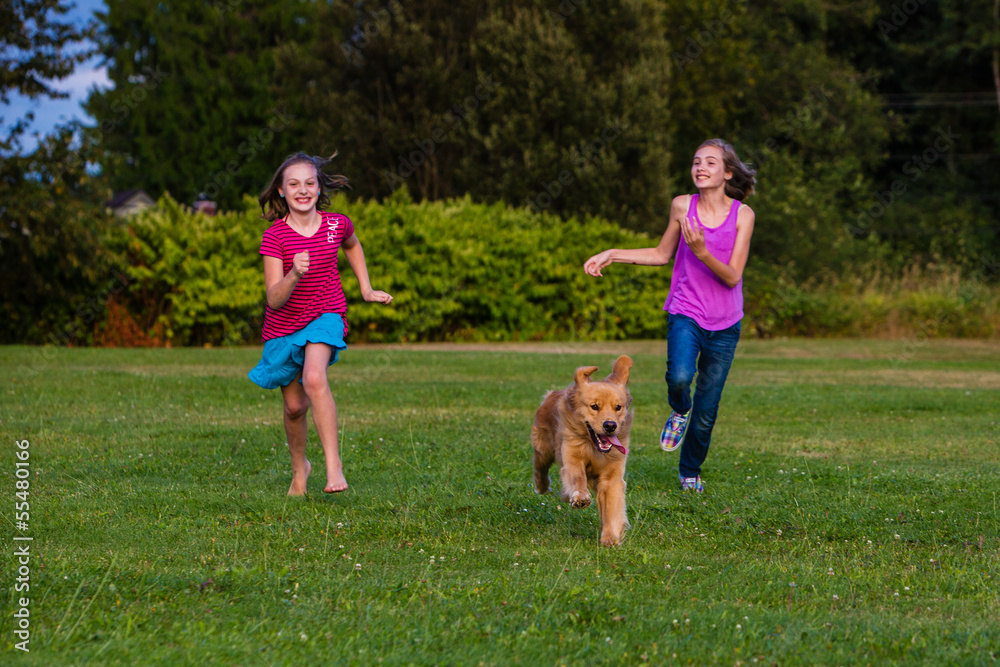 two girls running with a dog two girls running with a dog