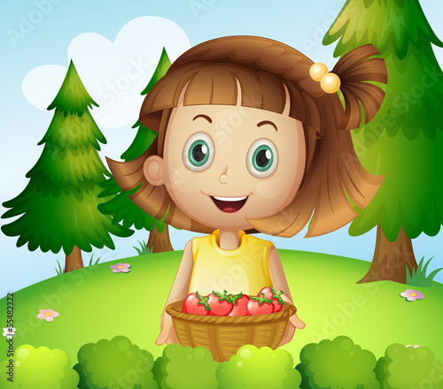 A smiling young woman holding a basket of strawberries
