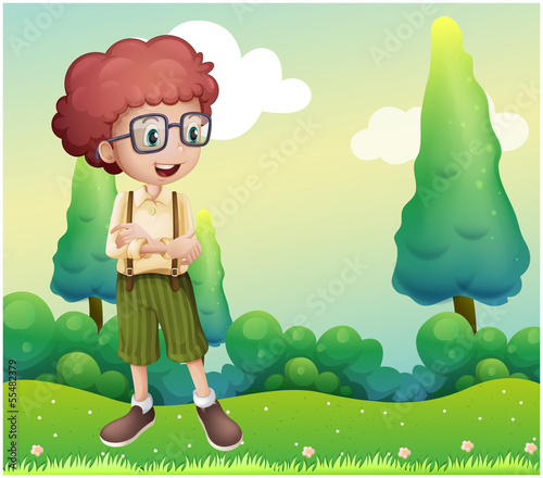 A curly boy standing at the hilltop