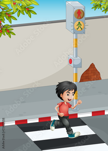 A boy running while crossing the street
