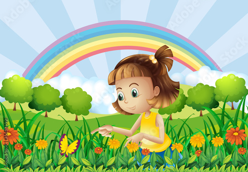 A girl at the garden with a rainbow at the back