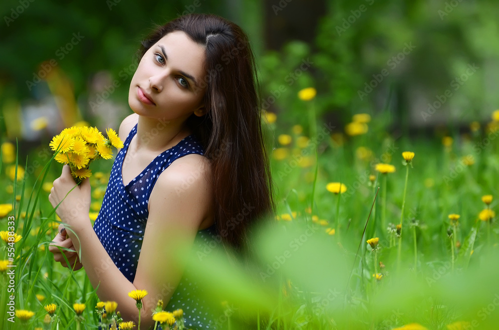 The beautiful woman in the field with dandelions The beautiful woman in the field with dandelions