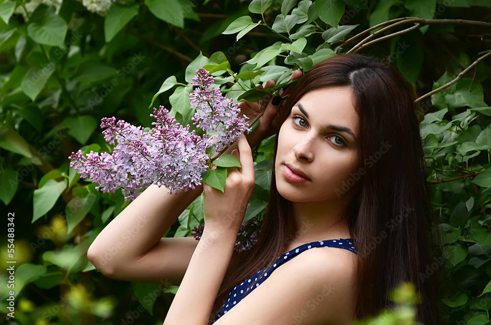The beautiful woman with flowers of a lilac The beautiful woman with flowers of a lilac