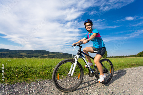 Fototapeta Naklejka Na Ścianę i Meble -  Healthy lifestyle - teenage girl biking