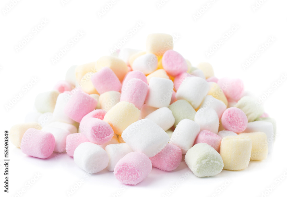 A pile of small colored puffy marshmallows isolated on white bac A pile of small colored puffy marshmallows isolated on white bac