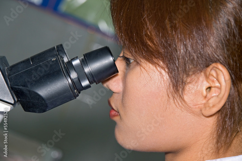 Woman working with a microscope