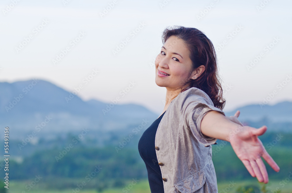 Pretty woman with opened arms expressing freedom