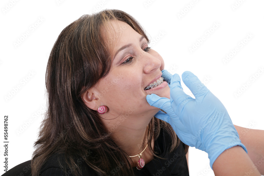 Female patient looking treating at her dentist Female patient looking treating at her dentist