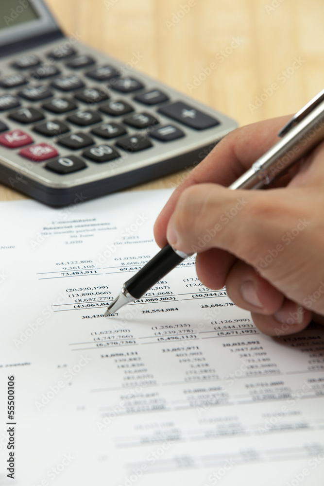 Financial report with calculator on table Financial report with calculator on table