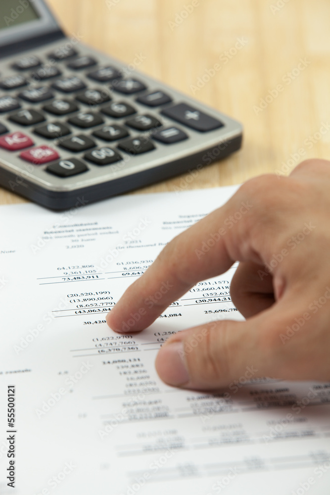 Financial report with calculator on table