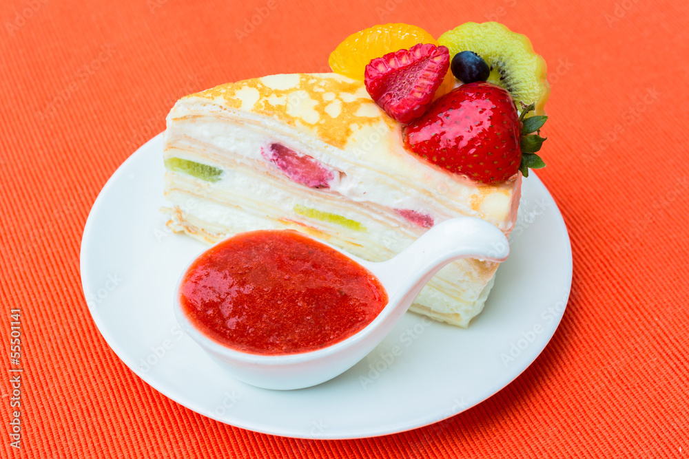 Crepes cake with orange, kiwi and strawberry sauce Crepes cake with orange, kiwi and strawberry sauce