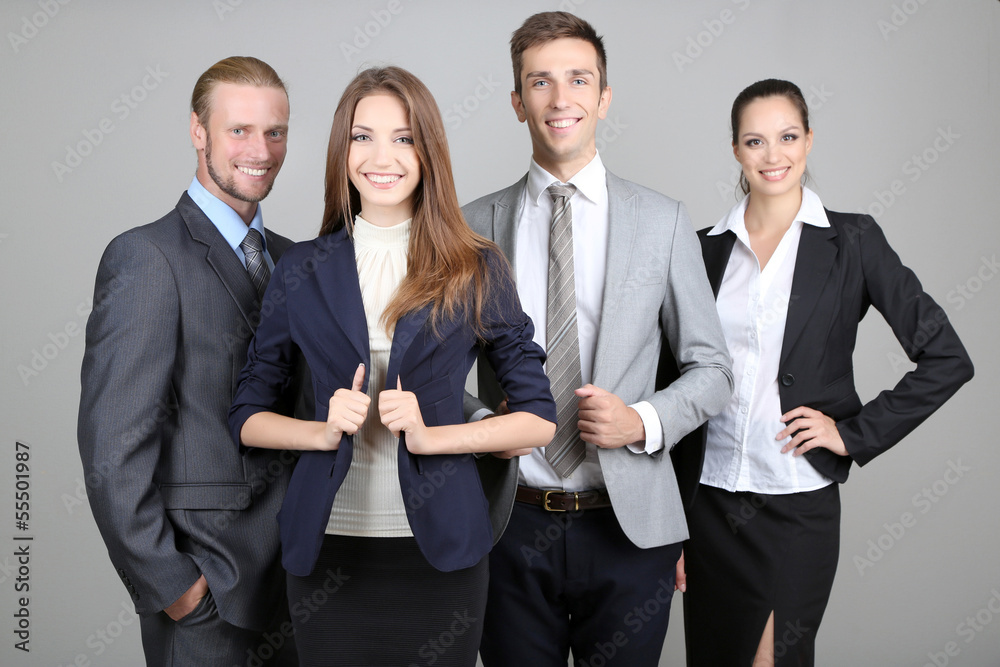 Business team standing in row on grey background Business team standing in row on grey background