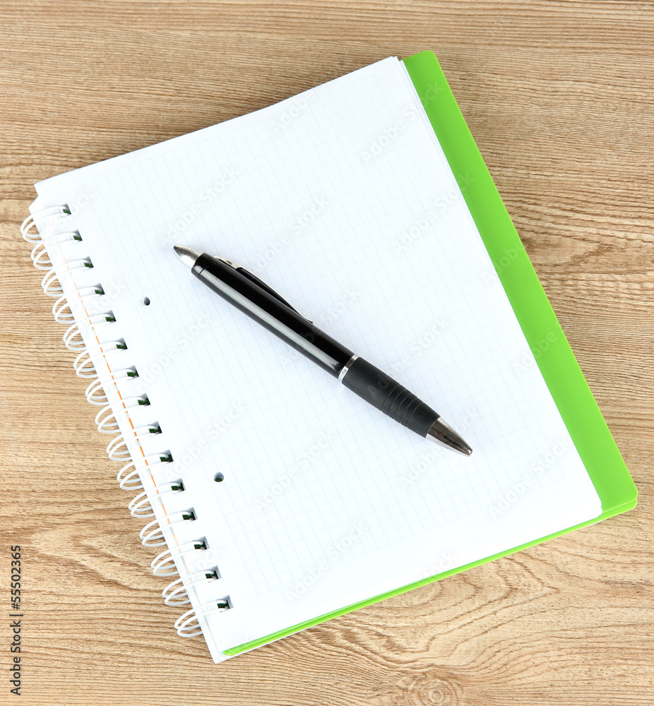 Notebook and pen on wooden table Notebook and pen on wooden table