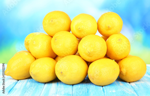 Ripe lemons on table on bright background