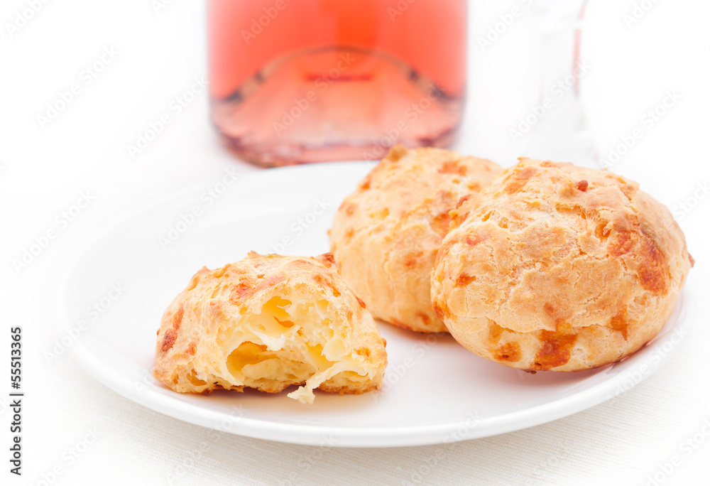 Gougeres, tiny French cheese buns, on a white plate. Gougeres, tiny French cheese buns, on a white plate.