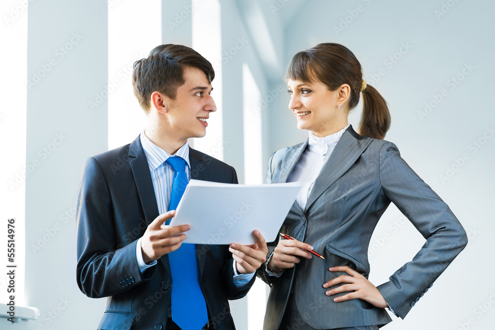 two business partners discussing reports two business partners discussing reports