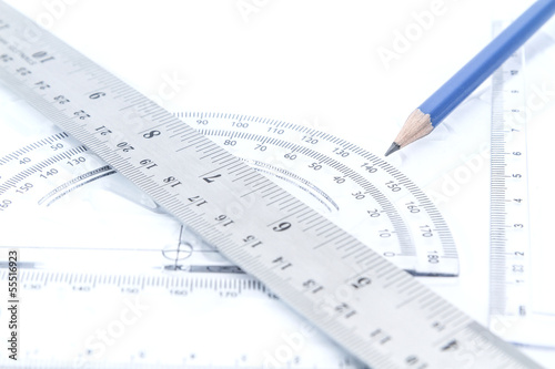 aluminium rulers and half circle scale blue pencil education geometry tool on white background. photo