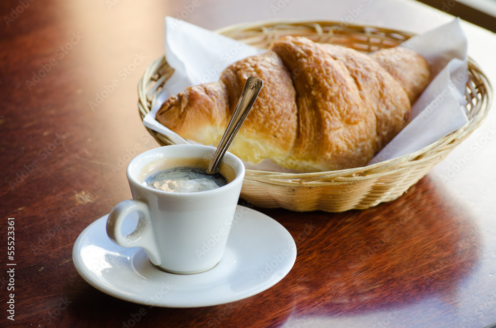 Cup of espresso with croissant