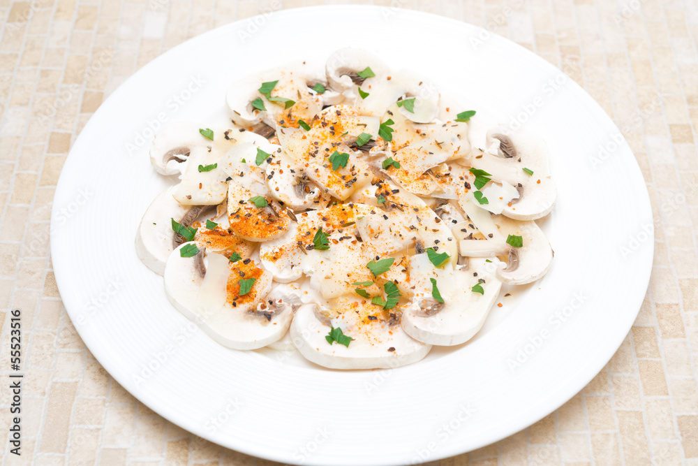salad of fresh mushrooms with red pepper, olive oil, herbs
