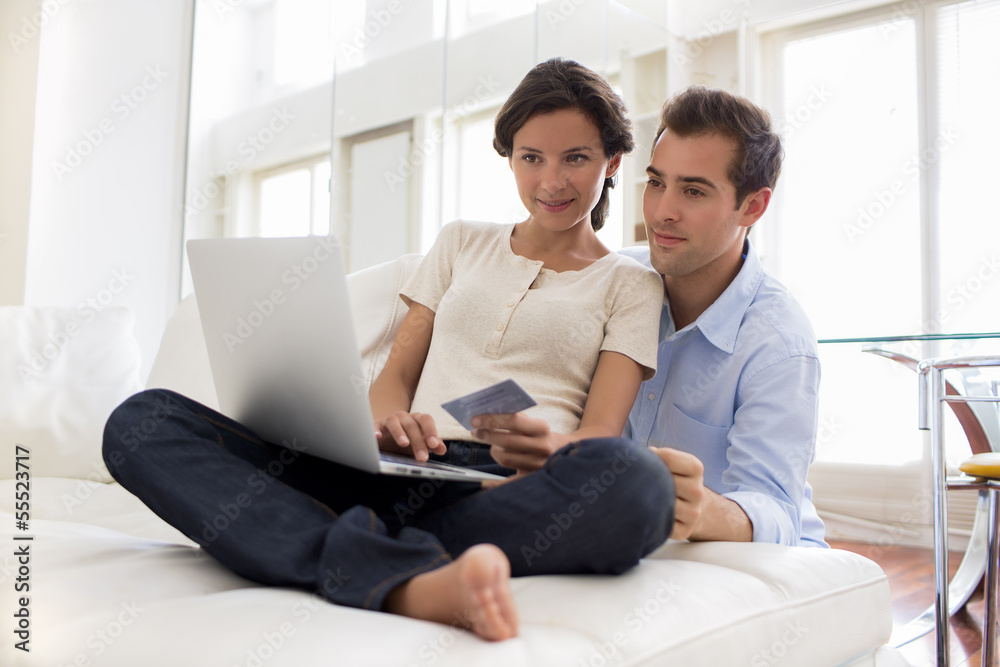 Couple using credit card to shop online indoor Couple using credit card to shop online indoor