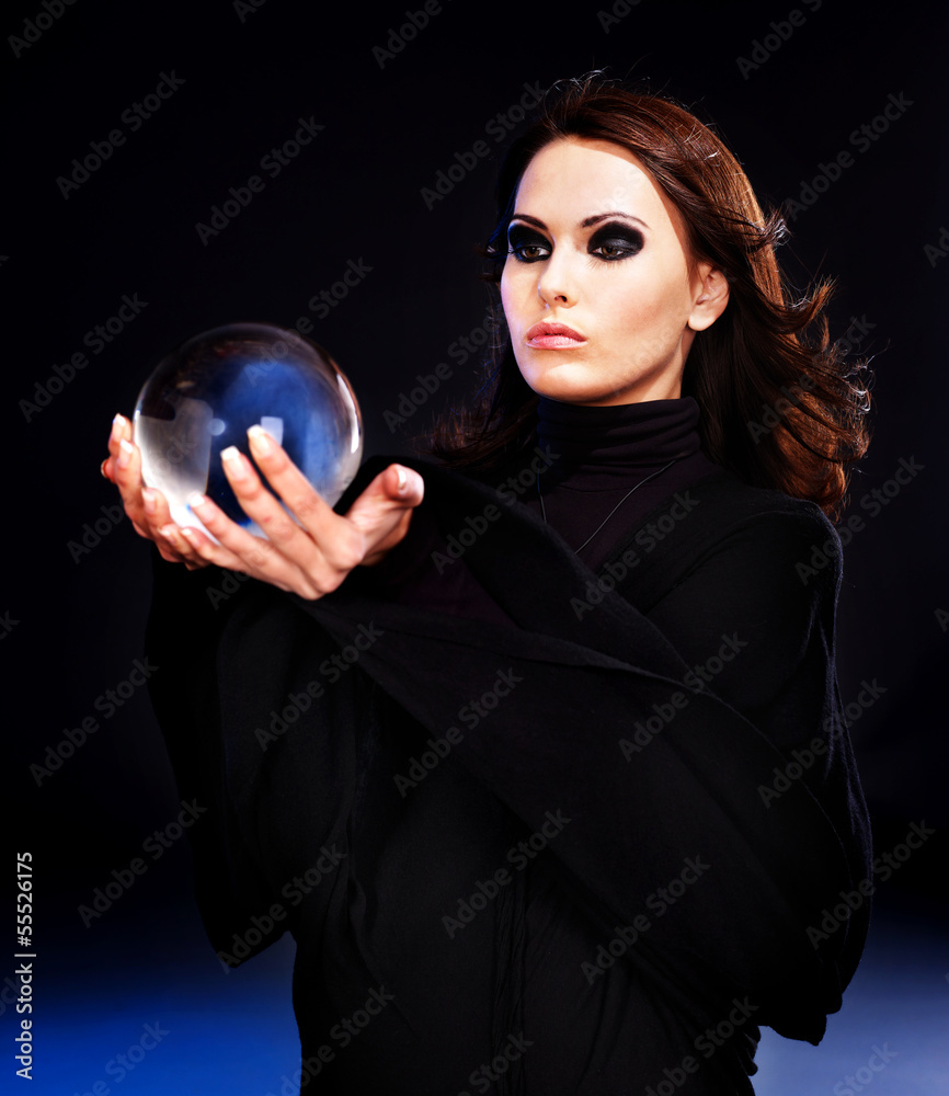 Naklejka premium Young woman with crystal ball.