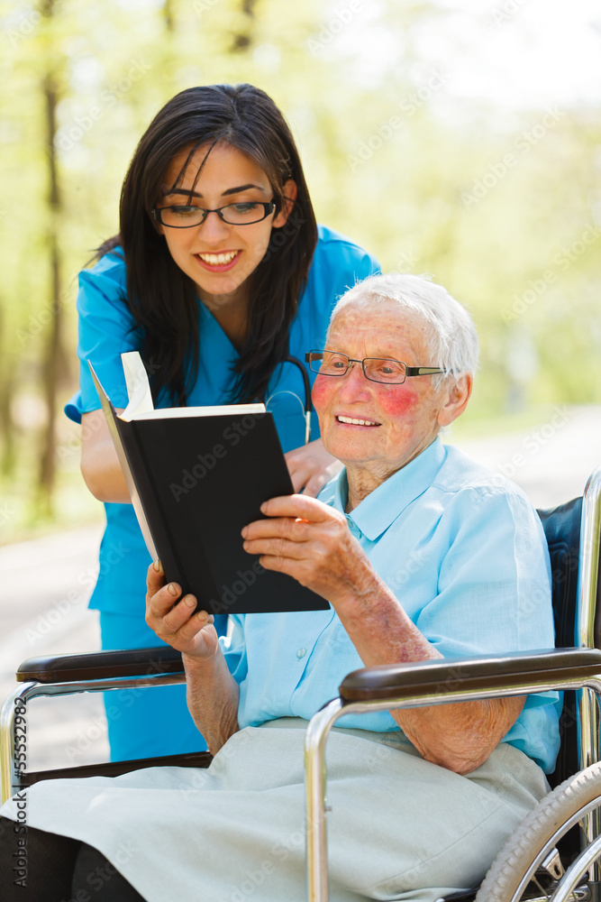 Elderly Lady in Wheelchair Reading