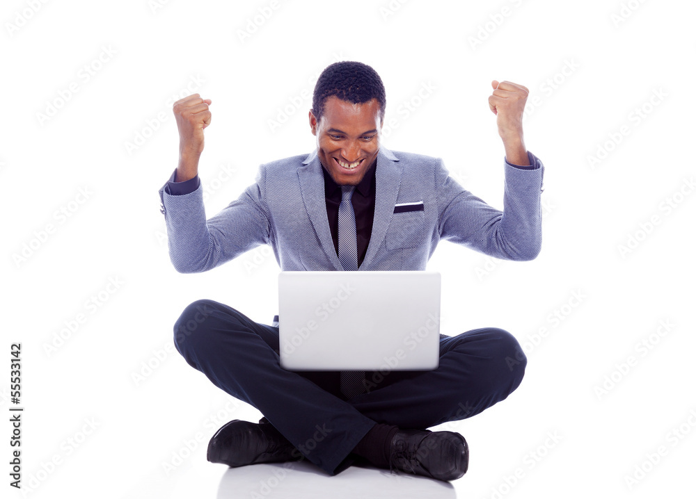 Winner business man with laptop sitting on the floor - isolated Winner business man with laptop sitting on the floor - isolated