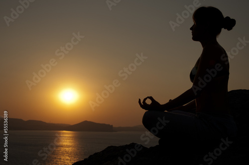 yoga pose silhouette at sunrise