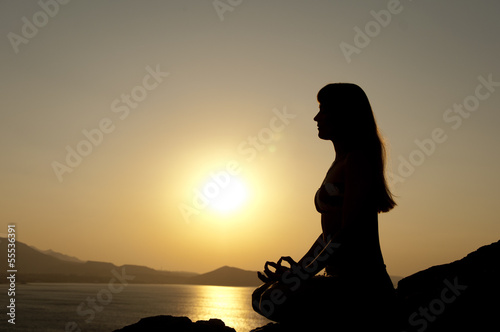 yoga pose silhouette at sunrise