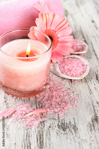 Beautiful spa setting with pink candle and flower