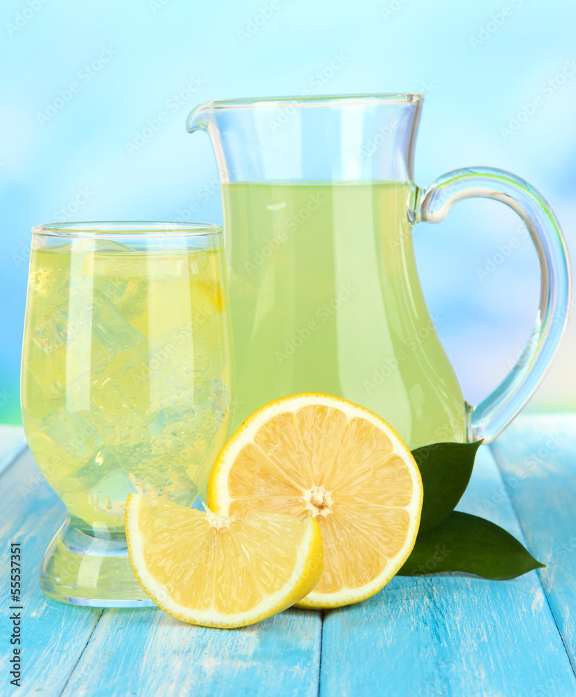 Delicious lemonade on table on blue background Delicious lemonade on table on blue background
