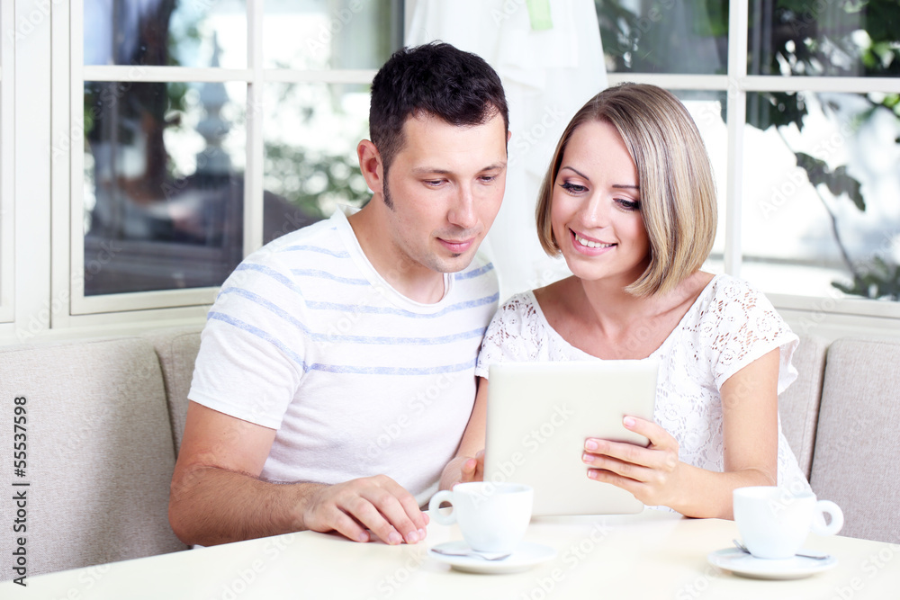 Young couple taking photo with tablet at home Young couple taking photo with tablet at home