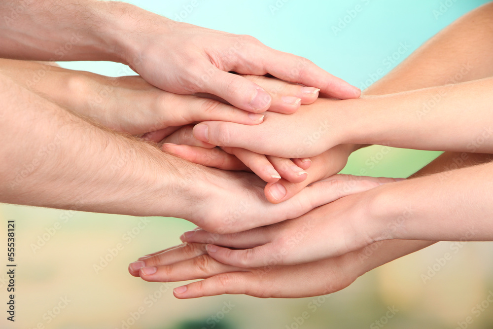 United hands on bright background. Conceptual photo of teamwork United hands on bright background. Conceptual photo of teamwork