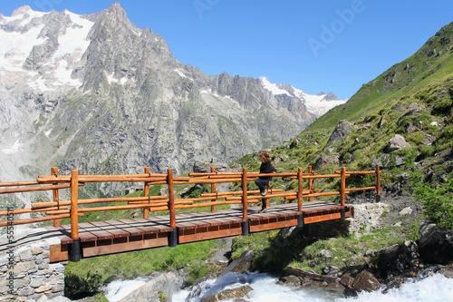 Hiking girl on a mountain bridge