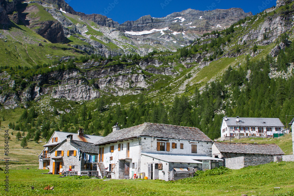 Small moutain village, white houses in Italian Alps