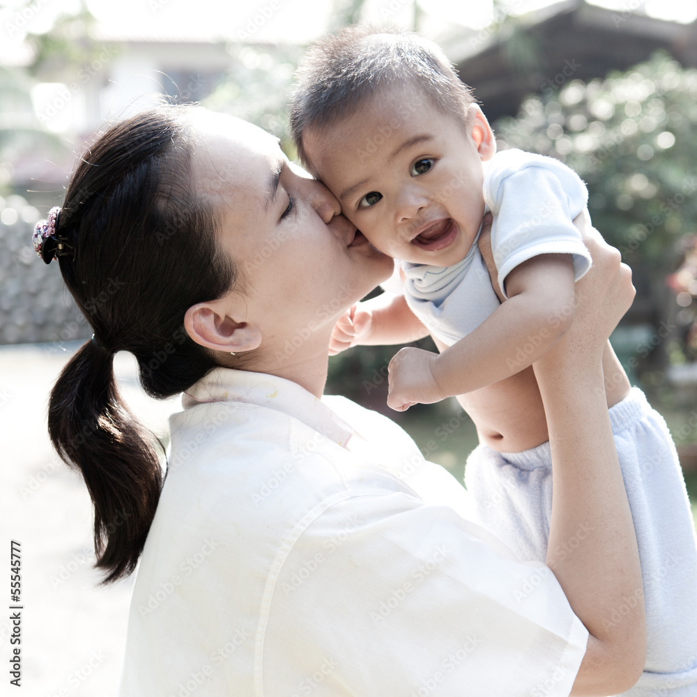 Fototapeta premium Asian mom kiss baby