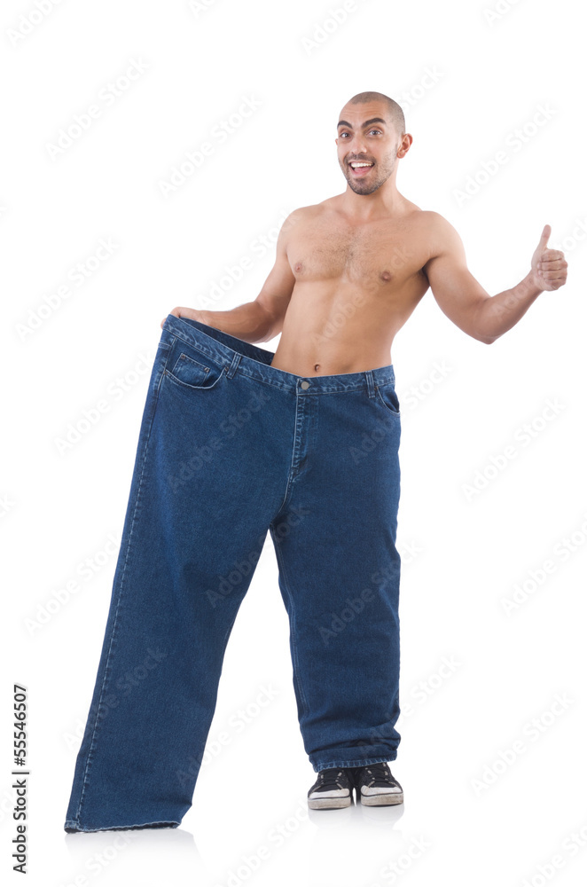 Man in dieting concept with oversized jeans Man in dieting concept with oversized jeans